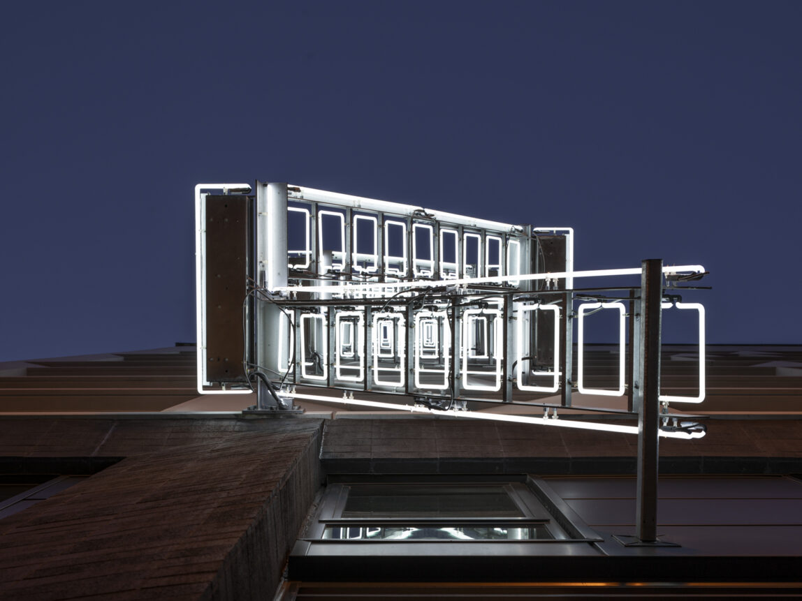 neon ladder sculpture from below angle