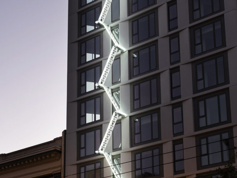 neon ladder sculpture on 50 Jones building